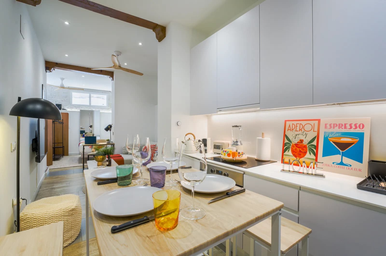 Galley kitchen and dining counter with playful Aperol and Espresso prints