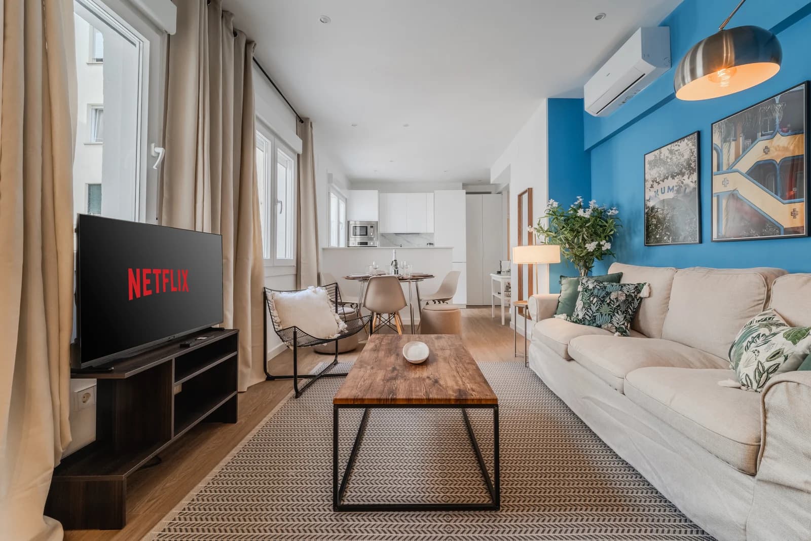 Living room with cobalt-blue accent wall, linen sofa and oak floors