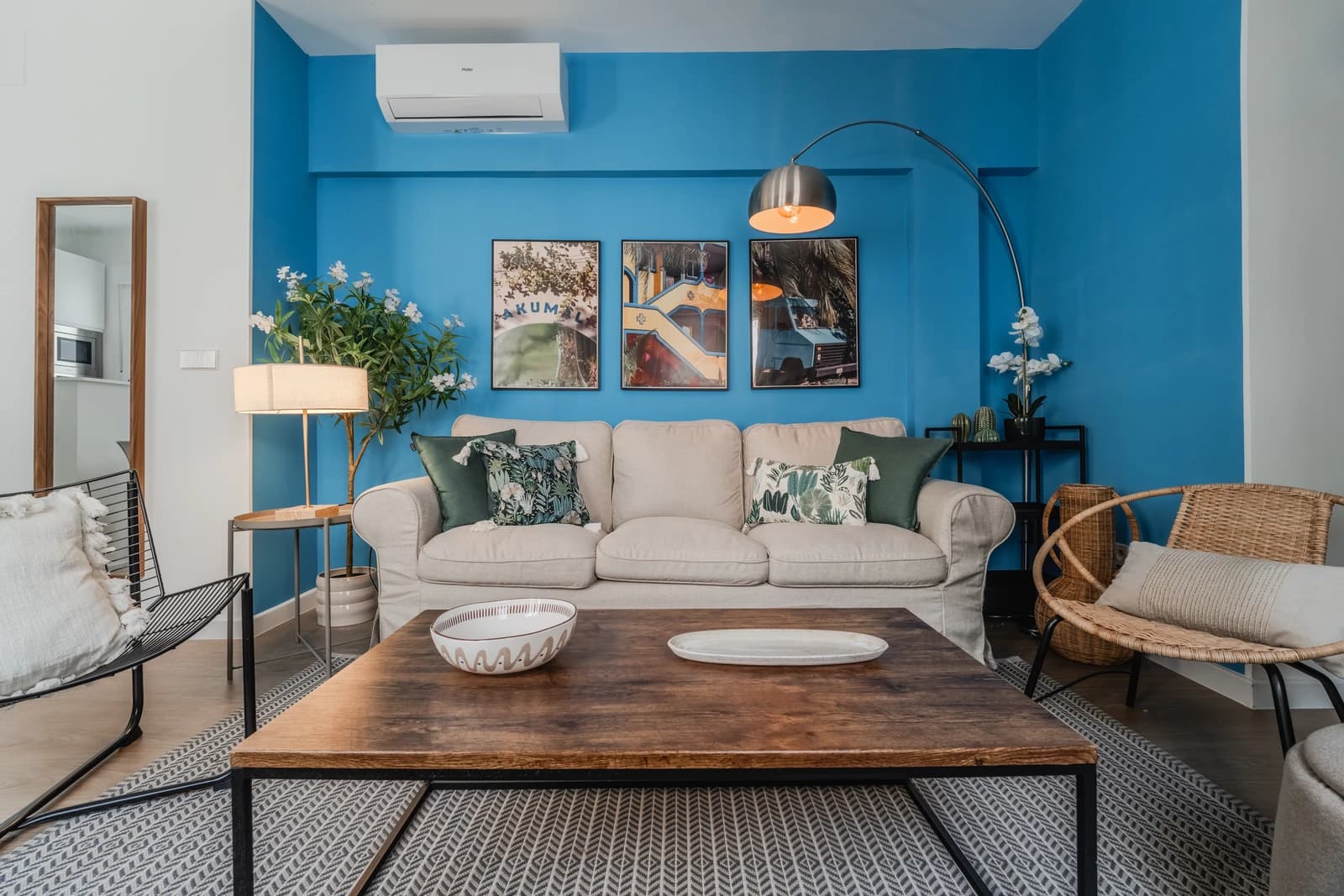 Living room with cobalt-blue accent wall, linen sofa and oak floors